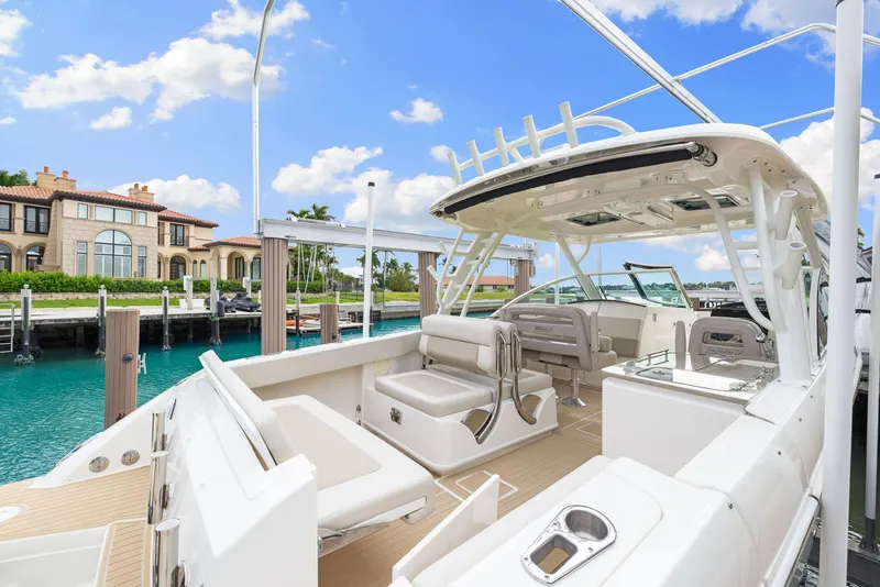 Slide: The Image of 2022 Boston Whaler 320 Vantage boat docked by luxury waterfront homes. - 11
