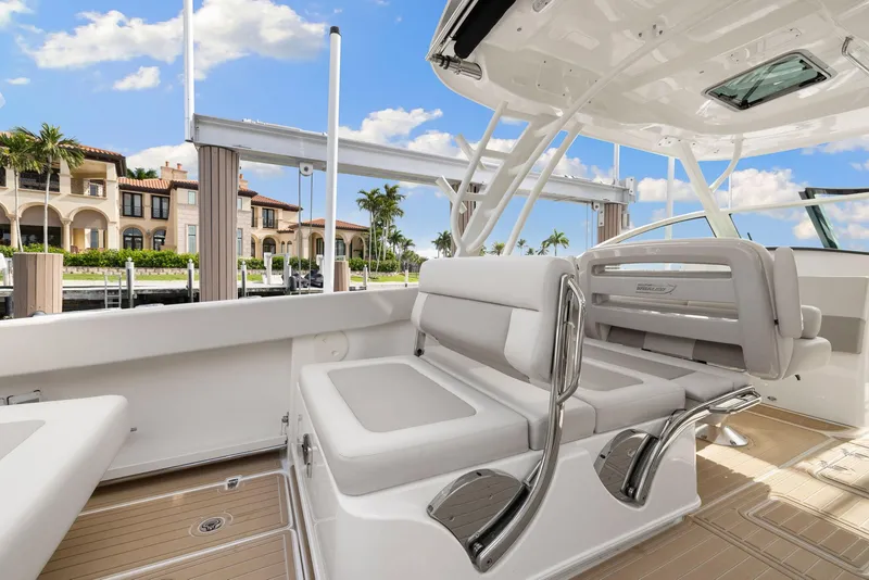 Slide: The Image of 2022 Boston Whaler 320 Vantage boat interior with luxurious seating and waterfront view. - 16