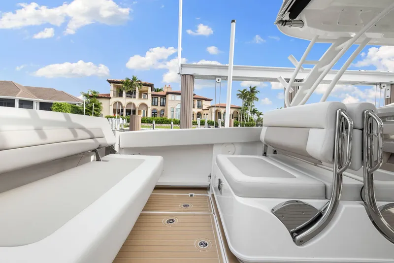 Slide: The Image of 2022 Boston Whaler 320 Vantage boat interior with luxurious seating and scenic waterfront view. - 22