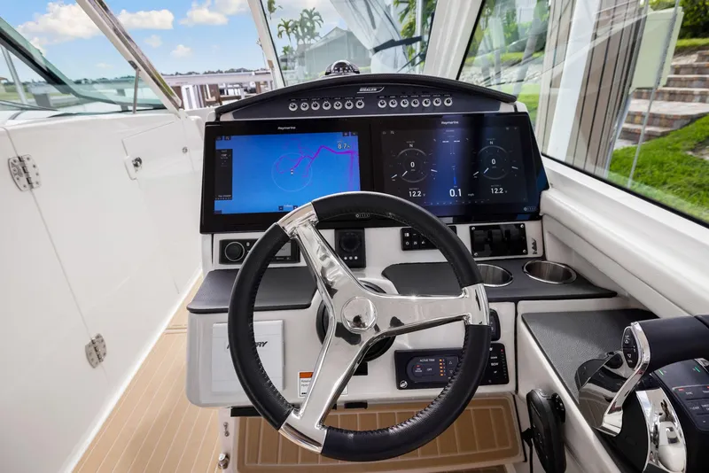 Slide: The Image of 2022 Boston Whaler 320 Vantage helm with dual displays and modern controls. - 26