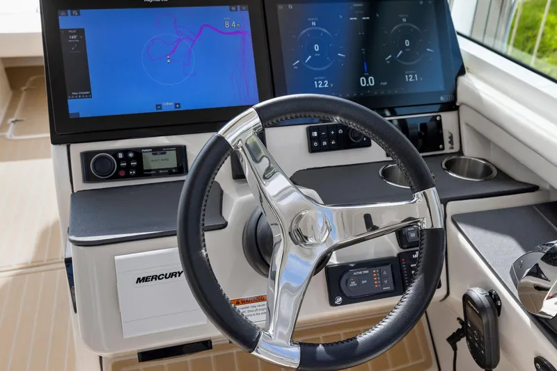 Slide: The Image of 2022 Boston Whaler 320 Vantage helm with dual navigation screens and steering wheel. - 28