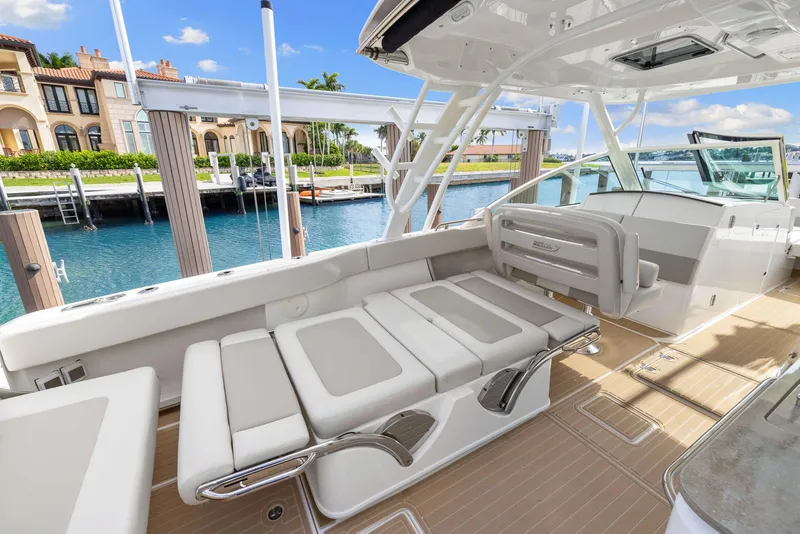 Slide: The Image of 2022 Boston Whaler 320 Vantage boat interior with luxurious seating and waterfront view. - 35