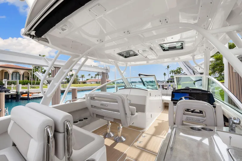 Slide: The Image of Interior view of 2022 Boston Whaler 320 Vantage boat, featuring luxurious seating and modern controls. - 36