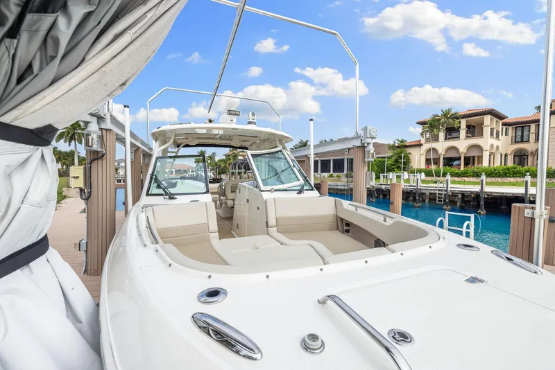 Slide: The Image of 2022 Boston Whaler 320 Vantage docked, showcasing luxury seating and sleek design. - 37