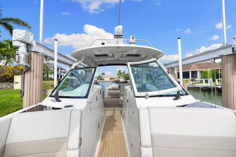 Slide: The Image of 2022 Boston Whaler 320 Vantage boat docked, showcasing sleek design and spacious interior. - 38