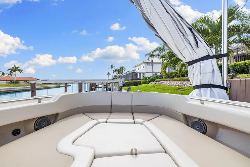 Slide: The Image of 2022 Boston Whaler 320 Vantage boat interior with waterfront view and palm trees. - 39