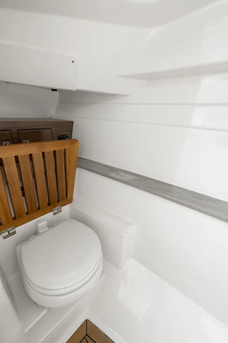 Slide: The Image of 2022 Boston Whaler 320 Vantage boat interior with modern white marine toilet. - 41