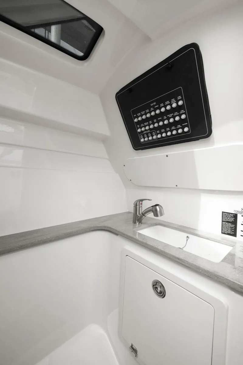 Slide: The Image of 2022 Boston Whaler 320 Vantage interior with sink and control panel. - 42
