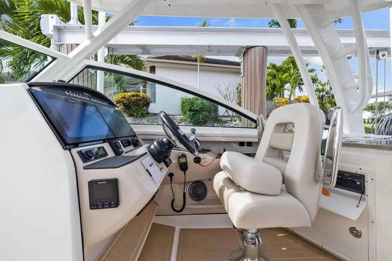 Slide: The Image of 2022 Boston Whaler 320 Vantage helm with modern controls and comfortable seating. - 45