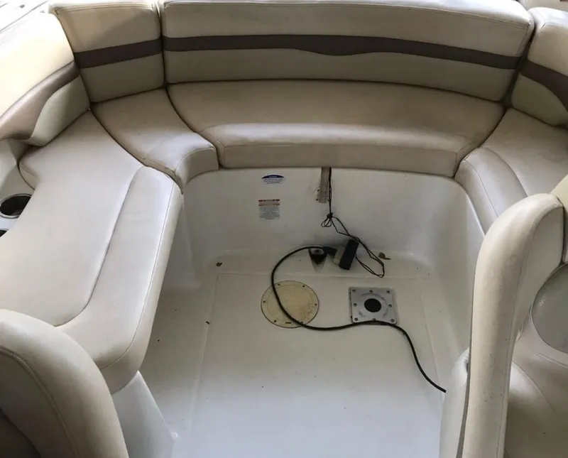 Slide: The Image of 2007 Chaparral Sunesta 234 boat interior with beige seating and storage area. - 5