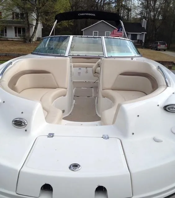 Slide: The Image of 2007 Chaparral Sunesta 234 boat with beige seating and American flag in residential area. - 7