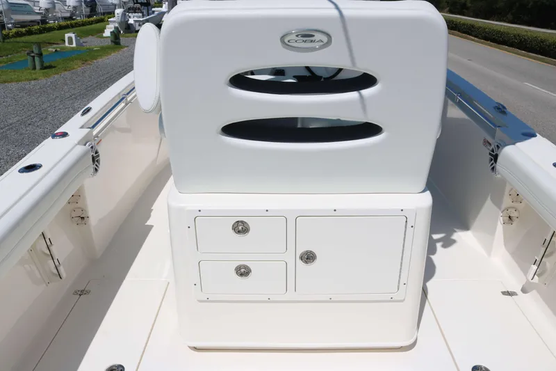 Slide: The Image of 2023 Cobia 240 CC boat interior with storage compartments and seating. - 11