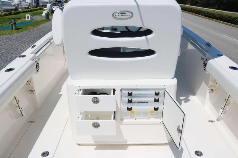 Slide: The Image of 2023 Cobia 240 CC boat interior with storage compartments and seating. - 12