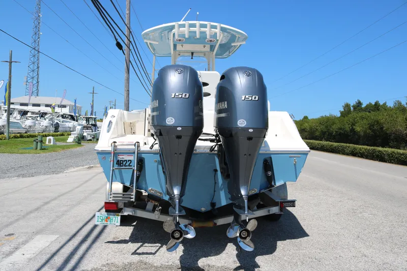 Slide: The Image of 2023 Cobia 240 CC boat with dual Yamaha 150 engines on a sunny day. - 5