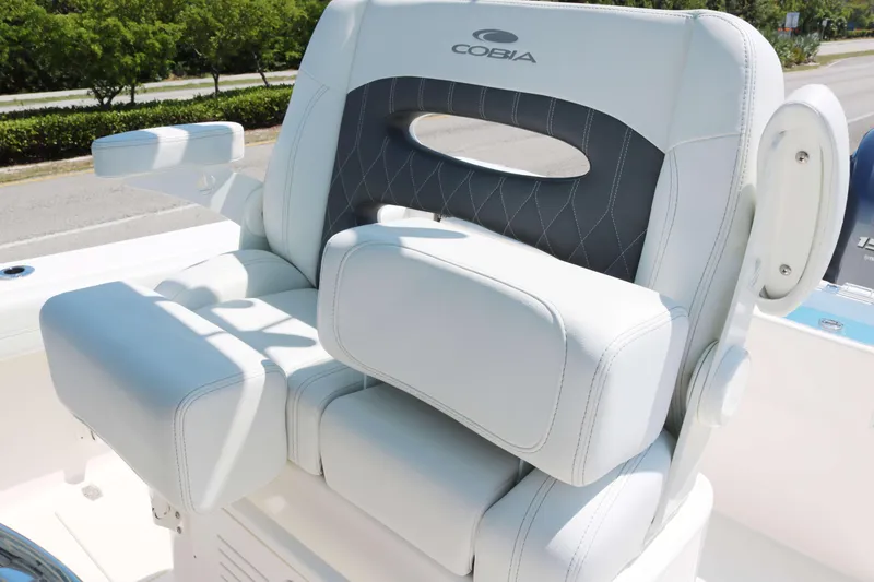 Slide: The Image of 2023 Cobia 240 CC boat seat with armrests and cushioned backrest. - 7