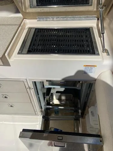 Slide: The Image of 2013 Grady-White Freedom 335 boat interior with grill and storage compartments. - 5