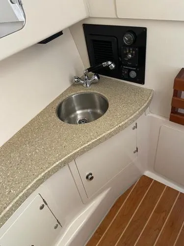 Slide: The Image of 2013 Grady-White Freedom 335 boat interior with sink and control panel. - 6