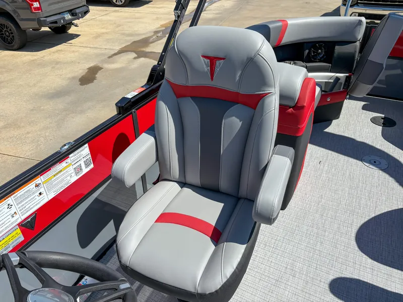 Slide: The Image of 2025 Trifecta 22RF CS boat seat, gray and red design, outdoor setting. - 10