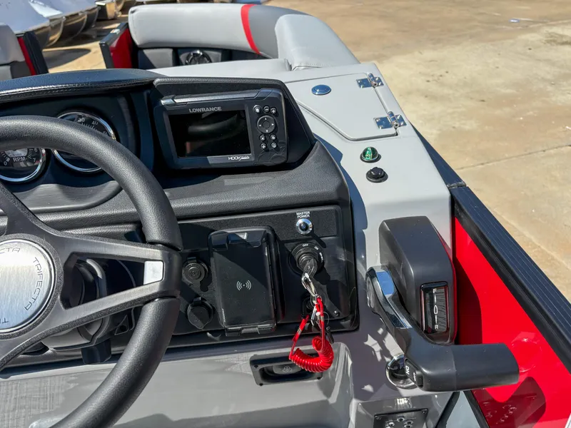 Slide: The Image of 2025 Trifecta 22RF CS boat dashboard with steering wheel, controls, and navigation system. - 16