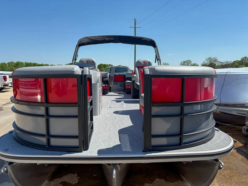 Slide: The Image of 2025 Trifecta 22RF CS pontoon boat with red and gray seating, docked outdoors. - 4