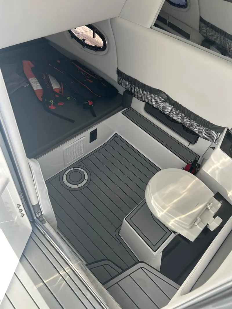 Slide: The Image of 2018 Nor-Tech 340 Sport cabin interior with toilet and seating area. - 12