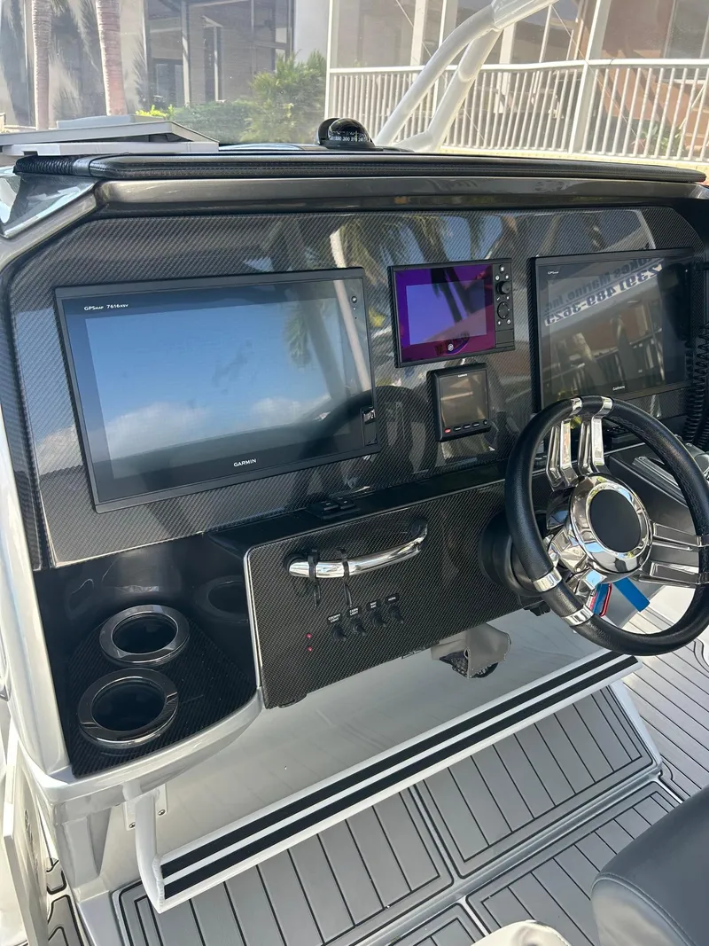 Slide: The Image of 2018 Nor-Tech 340 Sport dashboard with advanced navigation and control systems. - 14