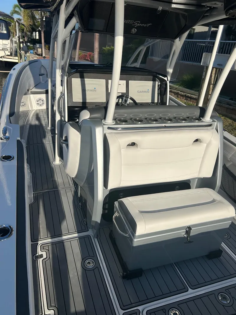 Slide: The Image of 2018 Nor-Tech 340 Sport boat interior with seating and console, featuring sleek design and modern amenities. - 15