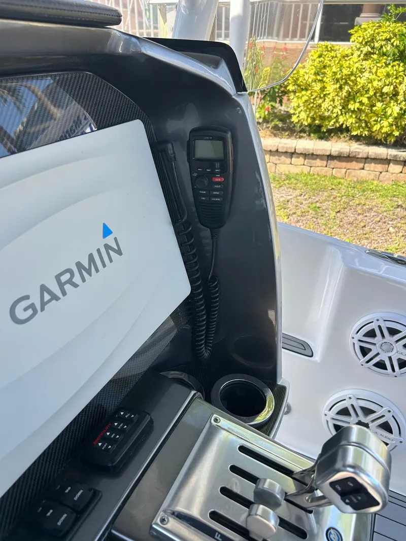 Slide: The Image of 2018 Nor-Tech 340 Sport boat console with Garmin navigation and controls. - 16
