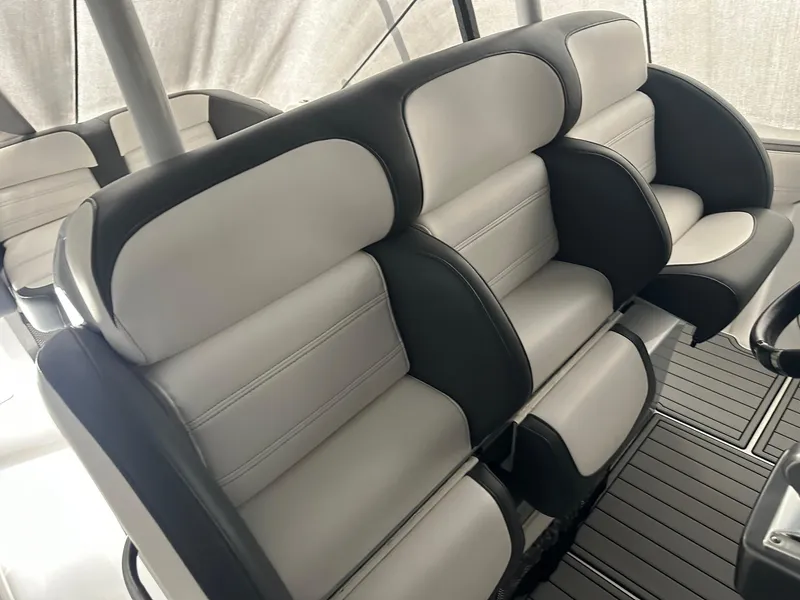 Slide: The Image of 2018 Nor-Tech 340 Sport boat interior with plush black and white seating. - 22