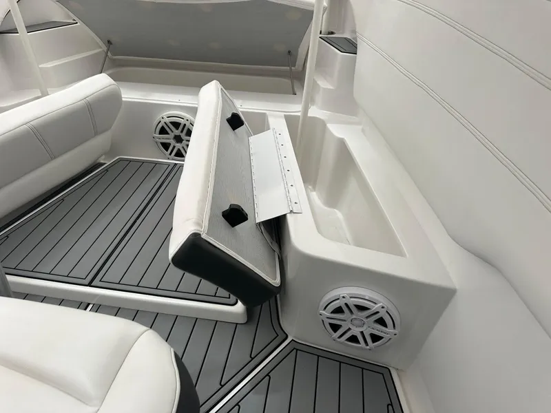 Slide: The Image of 2018 Nor-Tech 340 Sport interior with white seating, gray flooring, and built-in speakers. - 25