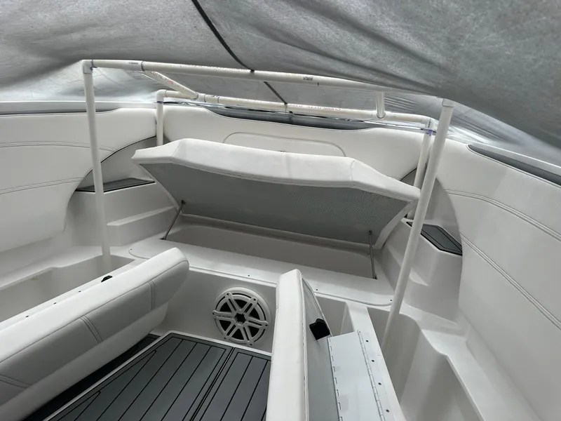 Slide: The Image of 2018 Nor-Tech 340 Sport boat interior with seating and storage under cover. - 5