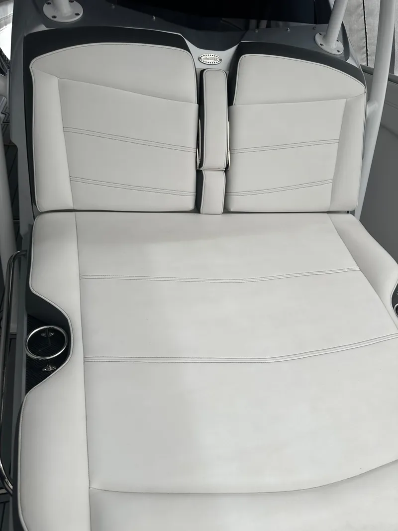 Slide: The Image of 2018 Nor-Tech 340 Sport boat with white leather seating and cup holders. - 6