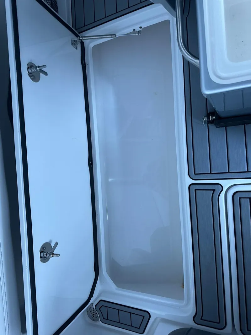 Slide: The Image of 2018 Nor-Tech 340 Sport boat storage compartment with open hatch and sleek interior design. - 8