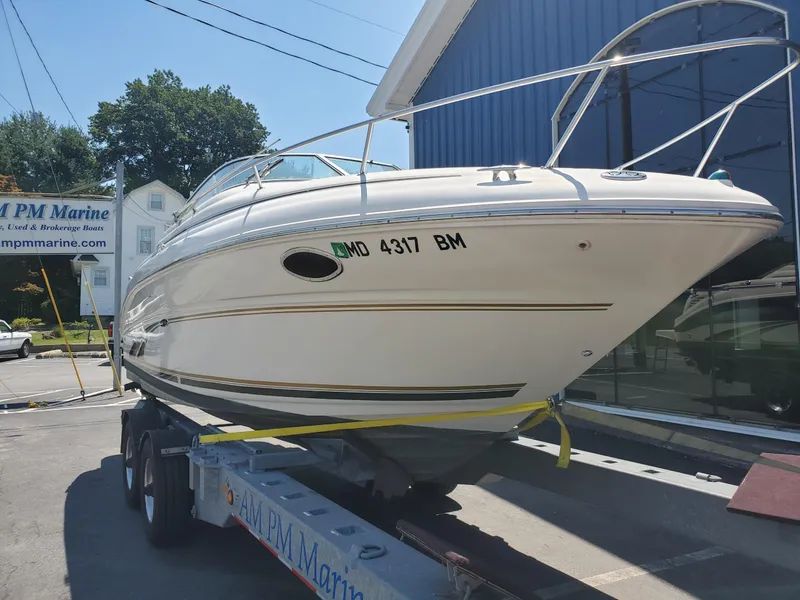 Slide: The Image of 2001 Sea Ray 245 Weekender boat on trailer at marina. - 2
