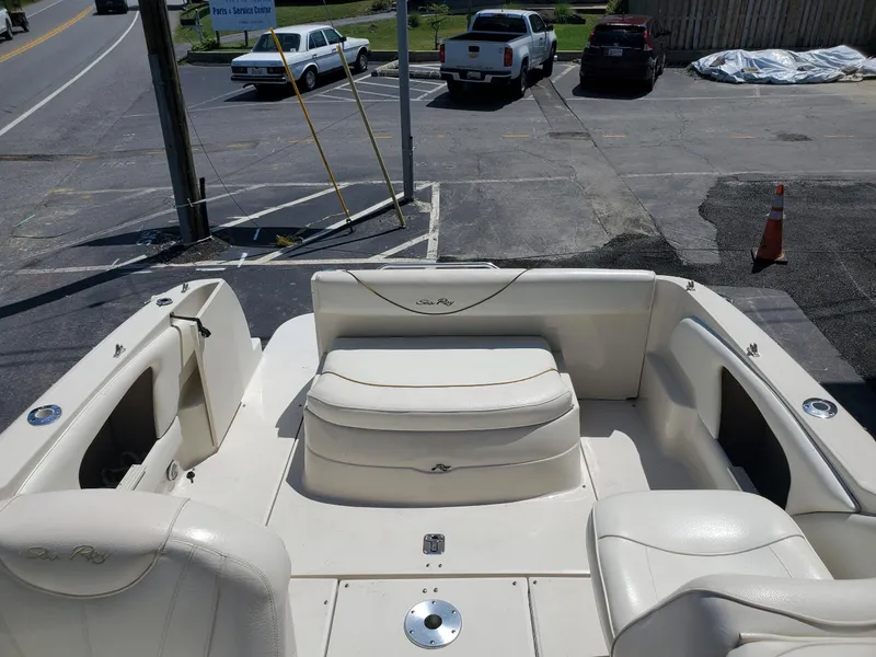 Slide: The Image of 2001 Sea Ray 245 Weekender boat interior with white seating and open deck area. - 6