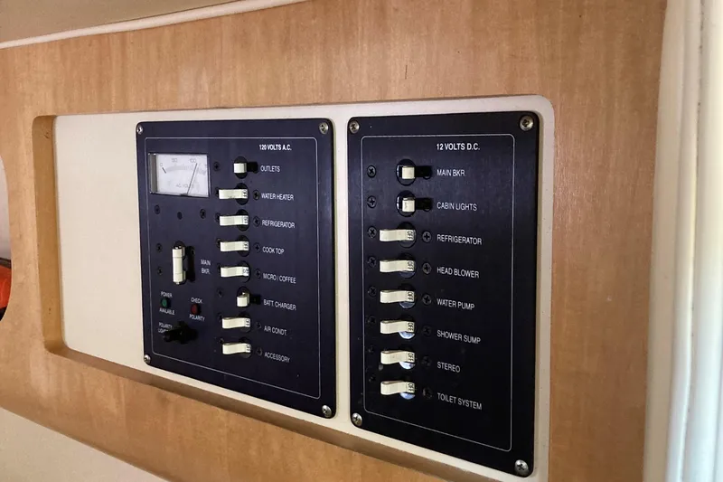 Slide: The Image of Control panel of a 2001 Chris-Craft 26 Constellation boat, featuring various switches and indicators. - 10