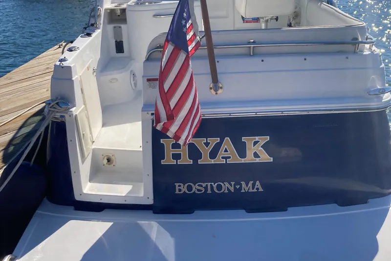 Slide: The Image of 2001 Chris-Craft 26 Constellation boat docked, displaying "HYAK" and American flag. - 11