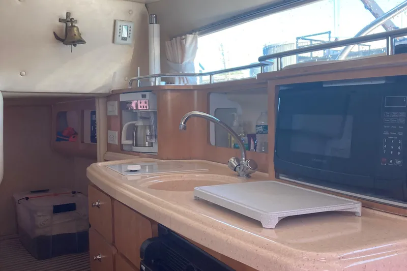 Slide: The Image of Interior of 2001 Chris-Craft 26 Constellation boat with kitchenette, sink, and microwave. - 2