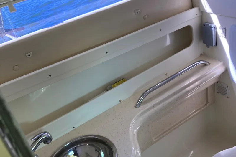 Slide: The Image of Interior view of a 2001 Chris-Craft 26 Constellation boat, featuring a sink and storage area. - 5