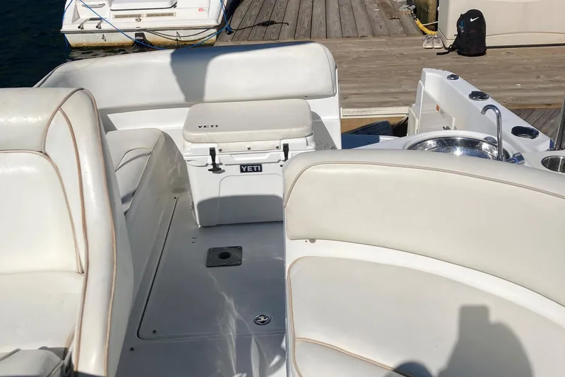 Slide: The Image of 2001 Chris-Craft 26 Constellation boat interior with white seating and Yeti cooler. - 9