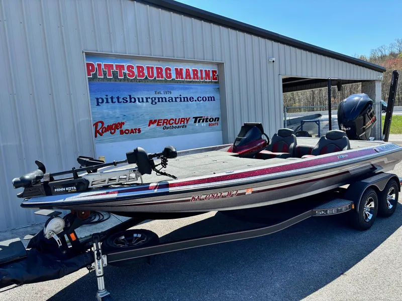 Slide: The Image of 2019 Skeeter ZX 250 boat at Pittsburg Marine dealership, featuring dual consoles and a trolling motor. - 1