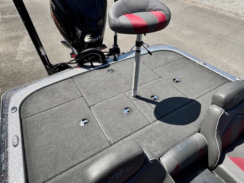 Slide: The Image of 2019 Skeeter ZX 250 boat deck with seating and motor, featuring gray and red upholstery. - 11
