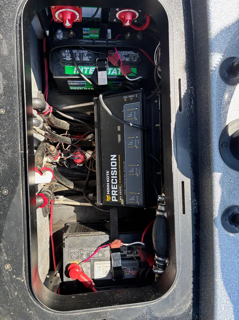 Slide: The Image of 2019 Skeeter ZX 250 boat battery compartment with Interstate batteries and Minn Kota Precision charger. - 12