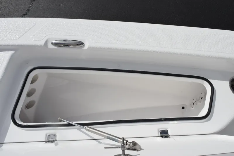 Slide: The Image of Open storage compartment on a 2025 Frontier 2104 boat, featuring a sleek white interior. - 16
