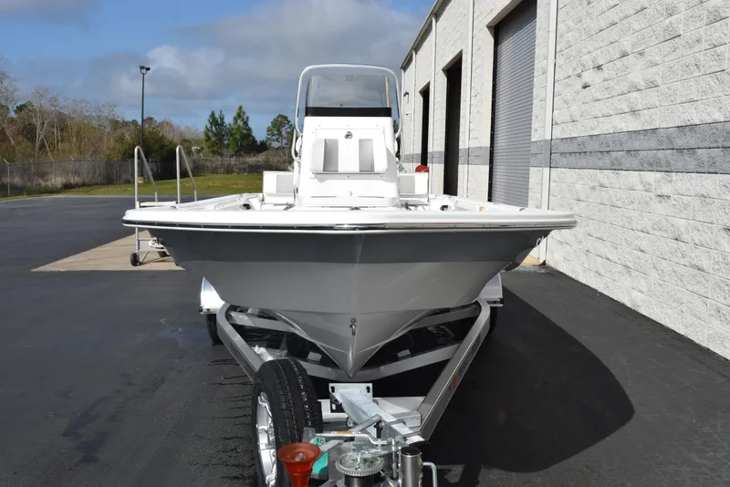 Slide: The Image of 2025 Frontier 2104 boat on trailer, parked near a building, under clear skies. - 3