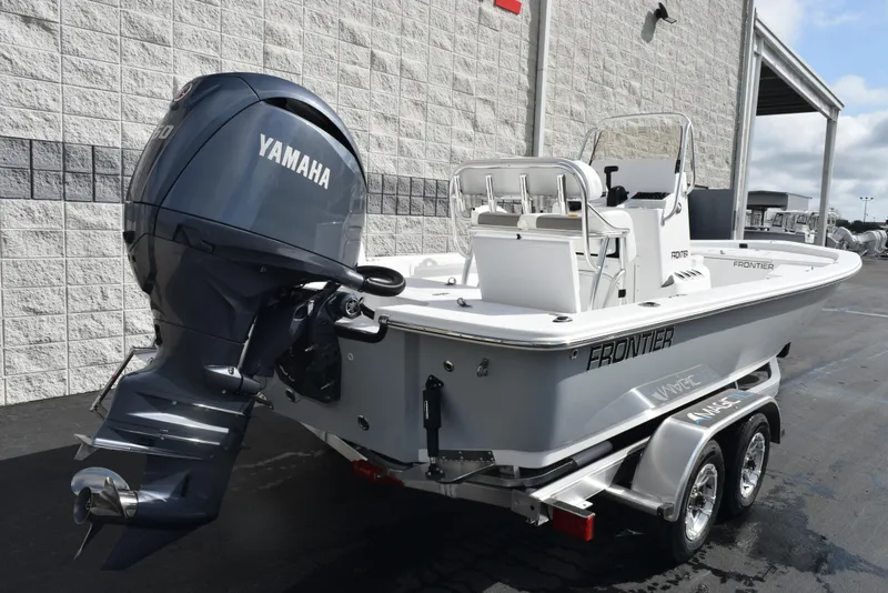 Slide: The Image of 2025 Frontier 2104 boat with Yamaha outboard motor on a trailer, parked outdoors. - 4