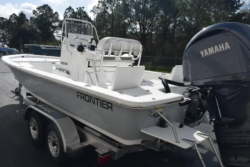 Slide: The Image of 2025 Frontier 2104 boat on trailer with Yamaha outboard motor, parked outdoors. - 6