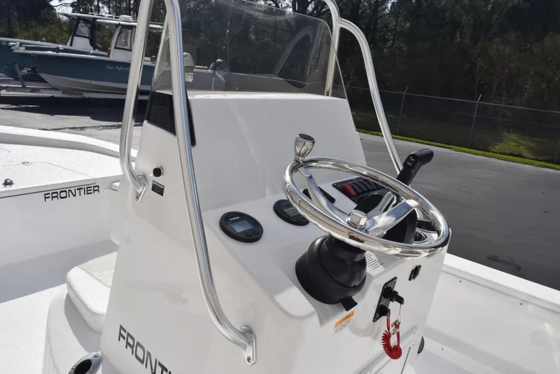 Slide: The Image of 2025 Frontier 2104 boat console with steering wheel and controls. - 8