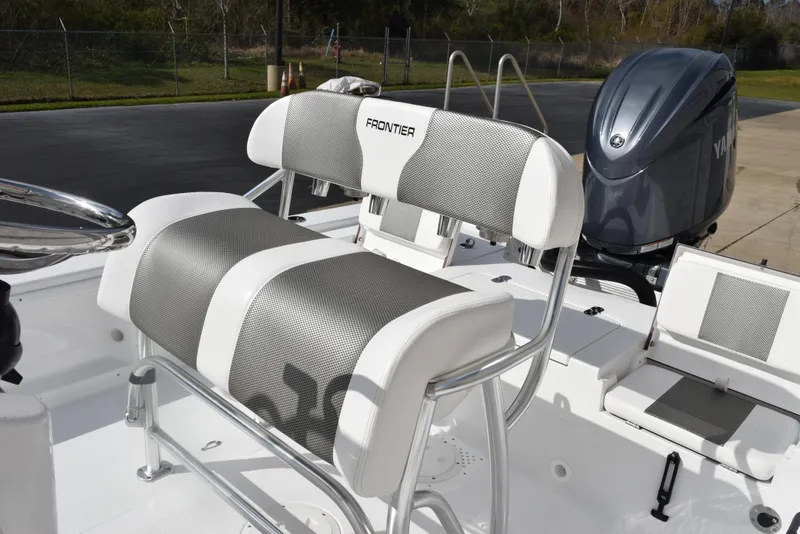 Slide: The Image of 2025 Frontier 2104 boat interior with cushioned seating and Yamaha outboard motor. - 9