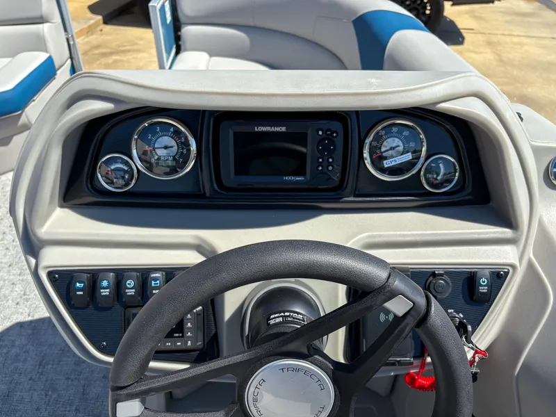 Slide: The Image of 2025 Trifecta 22 RF LE boat dashboard with steering wheel and control panel. - 14